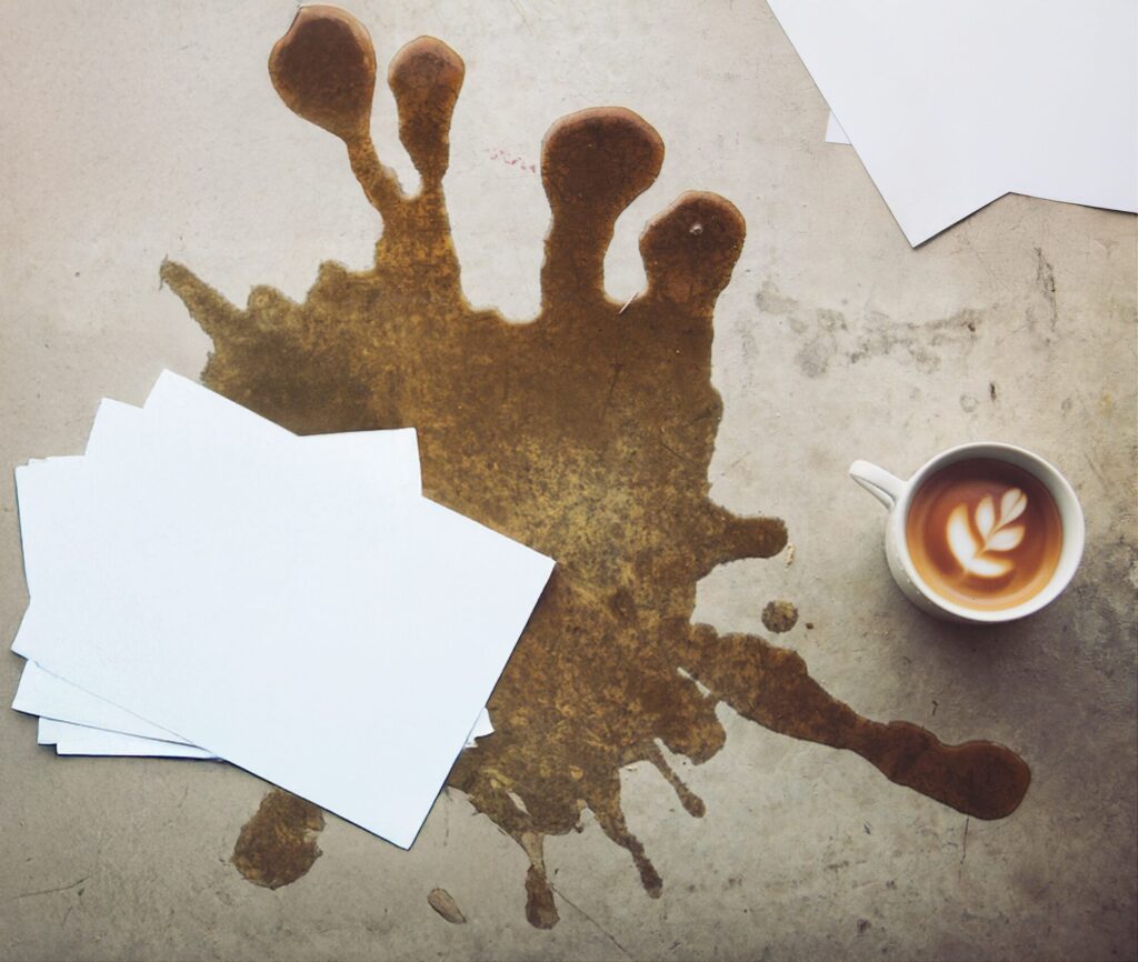 Spilled coffee on business papers symbolising wasted leads and lost opportunities in a broken sales process